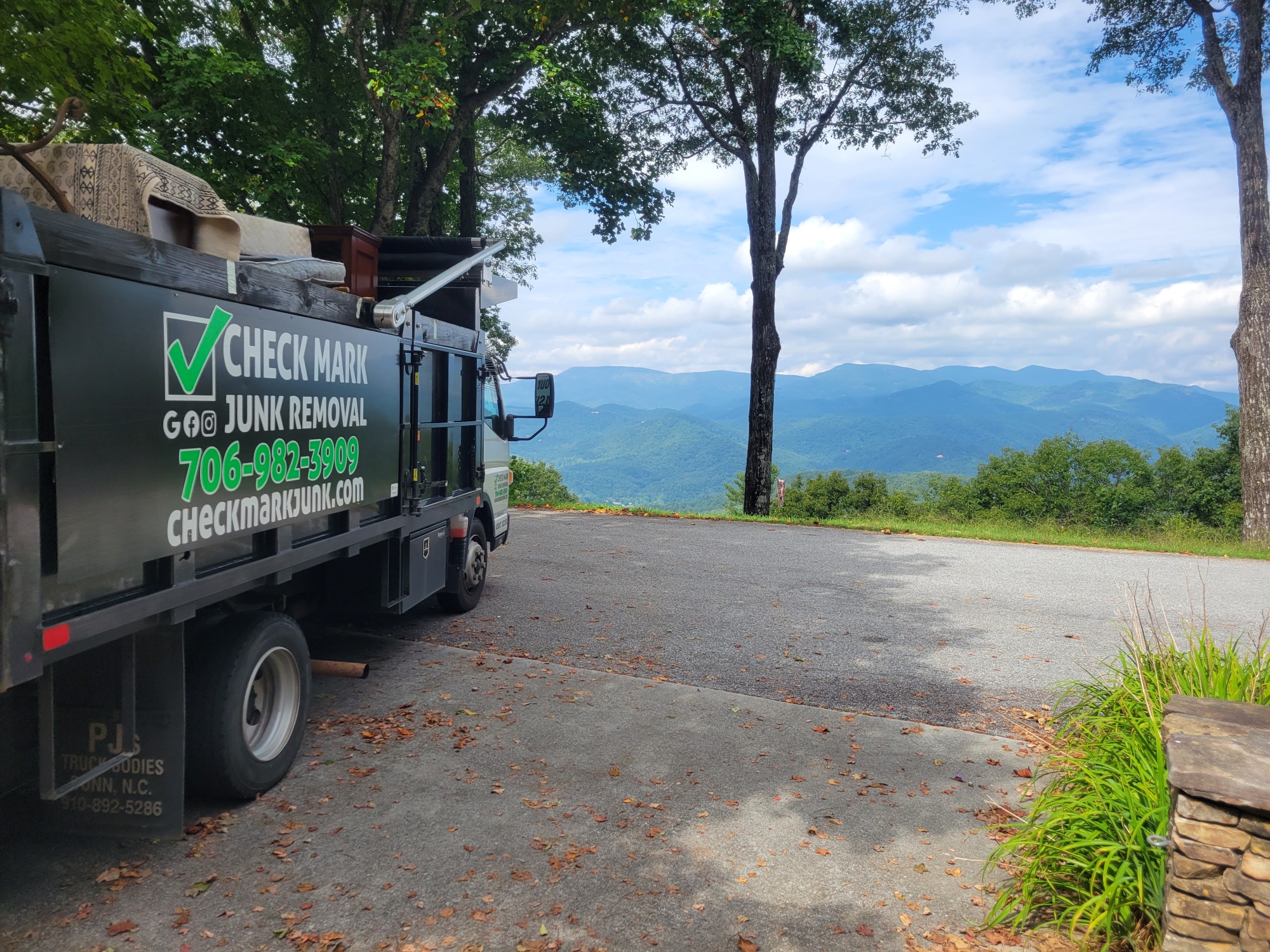 furniture removal - full junk removal truck with view of mountains in distance - Rabun County