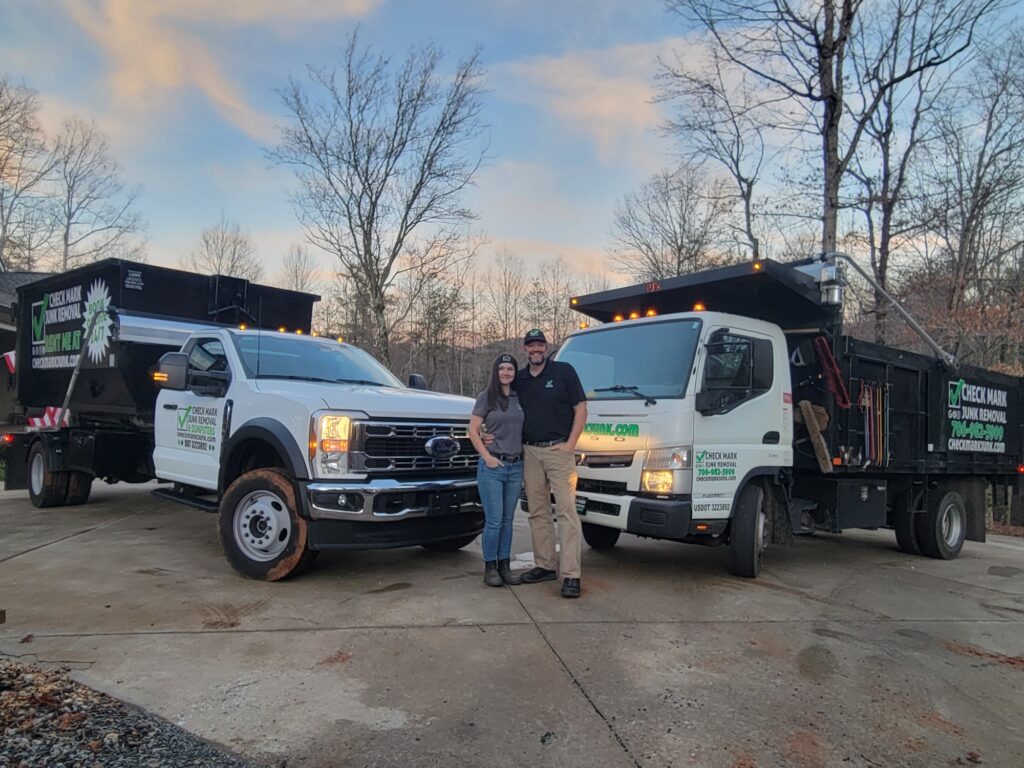 Check Mark Junk Removal owner operators in front of respective trucks