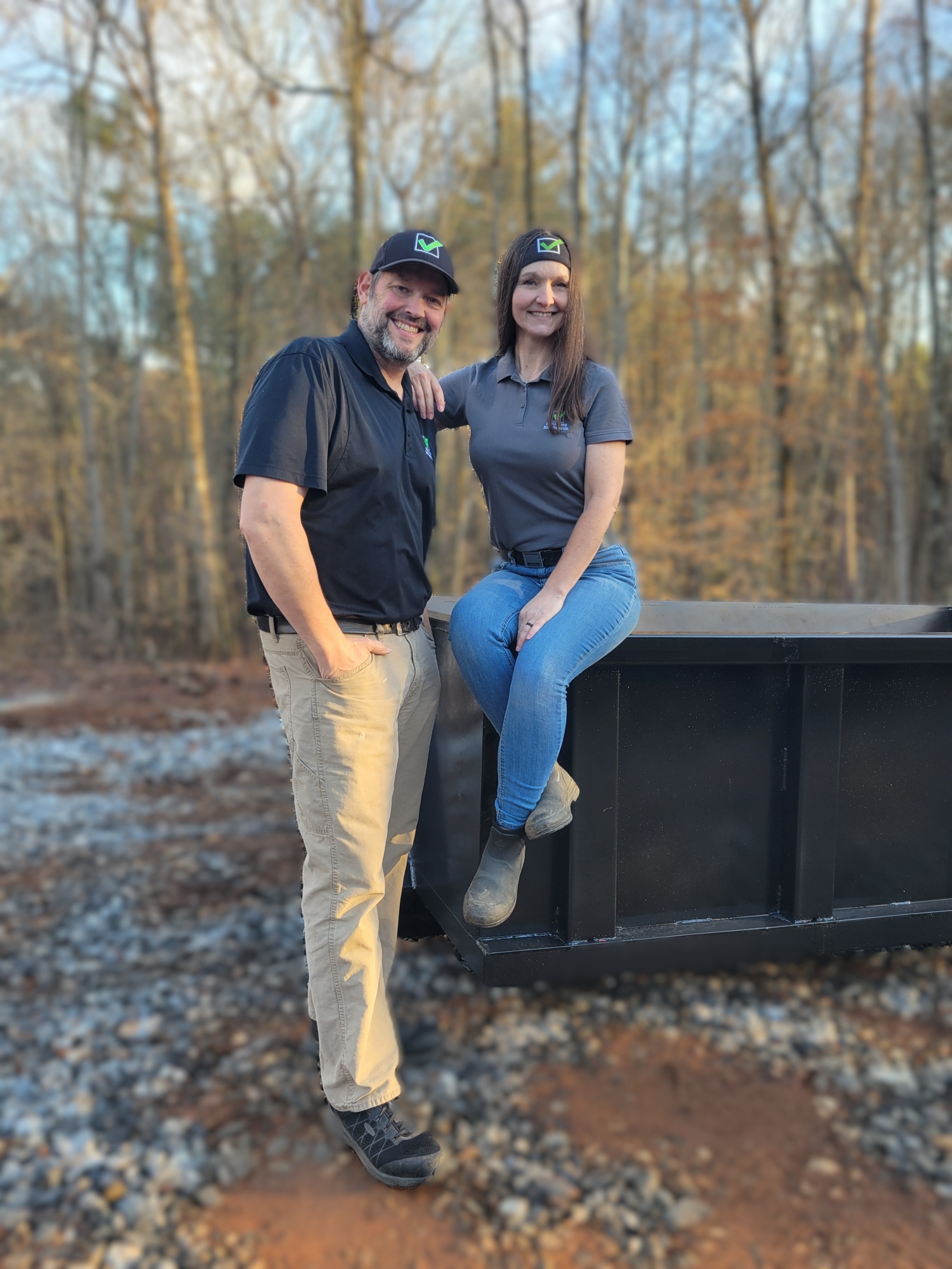 Contact Page - Check Mark Junk Removal owner operators with 7 yard construction dumpster